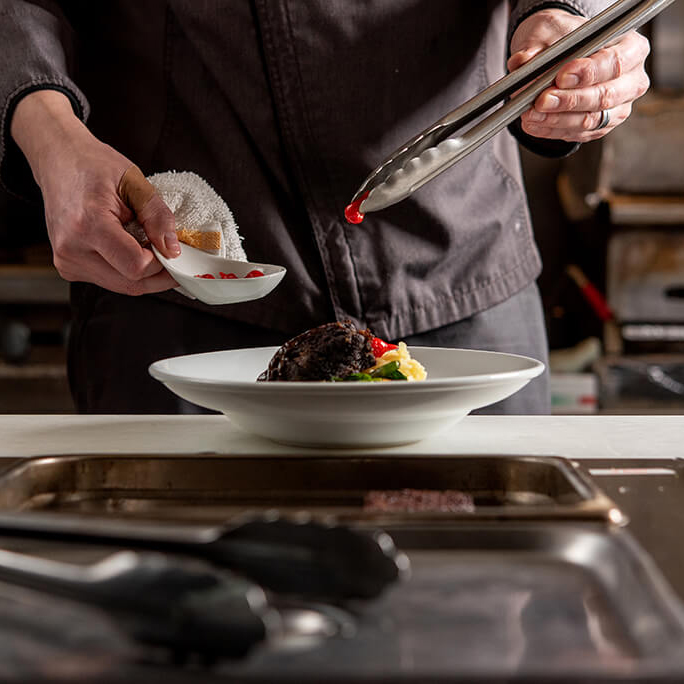 A chef preparing a meal for the Chocolat-e dinner.