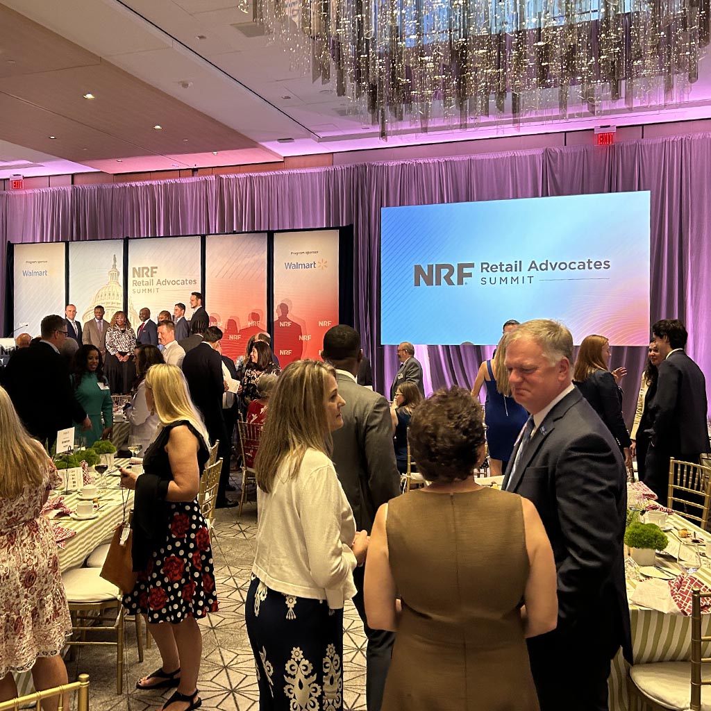 A large group of people in conversation at the Retail Advocates Summit.