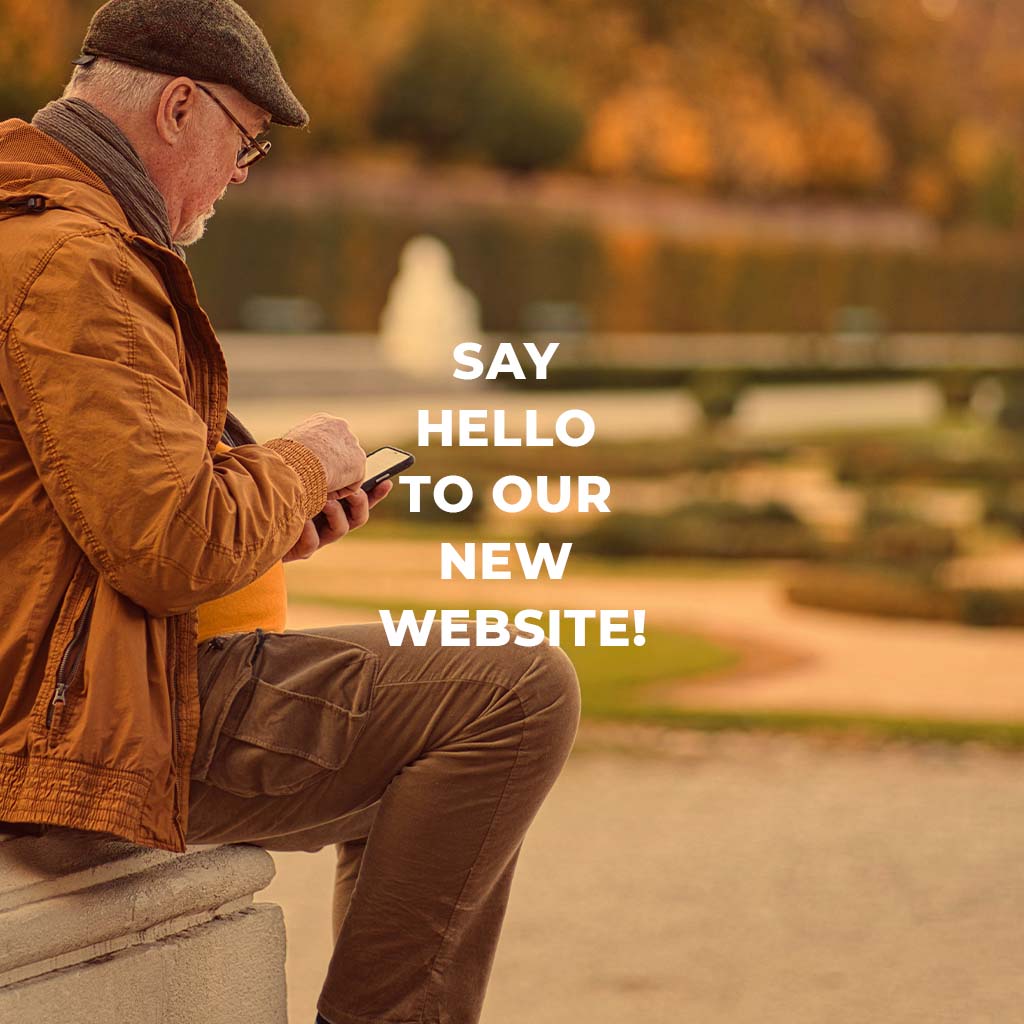 Say hello to our new website. An older person sits outside and is browsing their cell phone.